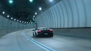 Black sports car driving fast through tunnel — Sports Cars