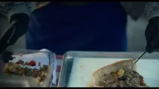 hand cutting sandwich on metal tray — The Bear