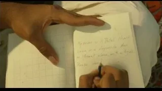 Hand writing shipwreck message on notebook — Life of Pi