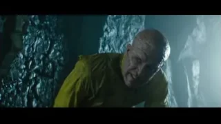 man in yellow jacket distressed in cave — Deadpool 2