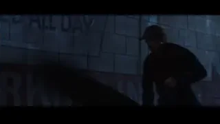 Man leaning against brick wall with graffiti — Iron Man 3