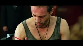 man writing with red pen at table — Lucy