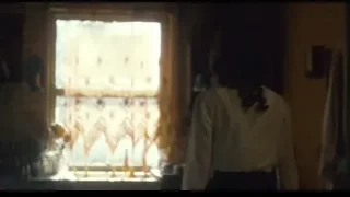 woman in kitchen looking out window — Peaky Blinders