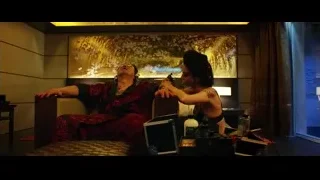 woman tattooing man in a room — Lucy
